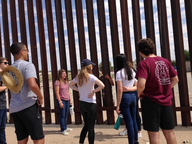 Students talk with residents of Mexico at the border fence in Texas. Students talk with residents of Mexico at the border fence in Texas.